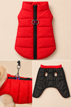 A pet puffer vest shown in three views on a light beige background: a front view with a red body, black zipper, and silver ring hardware; a close-up of the side with a leash attachment and collar; and a back view that is black with red trim and two oval cutouts.