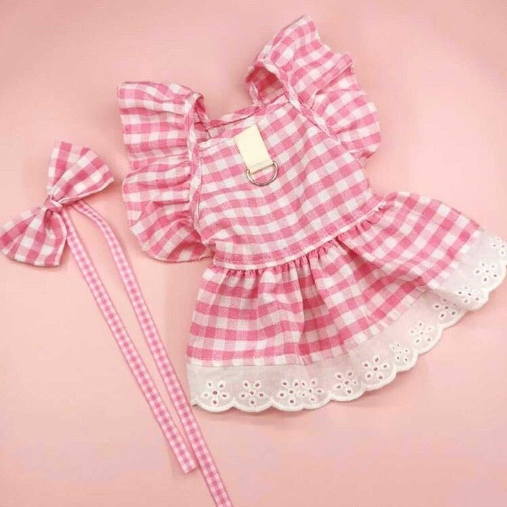 Sweet pink gingham dog dress with eyelet lace trim, ruffled sleeves, back bow, and matching leash.