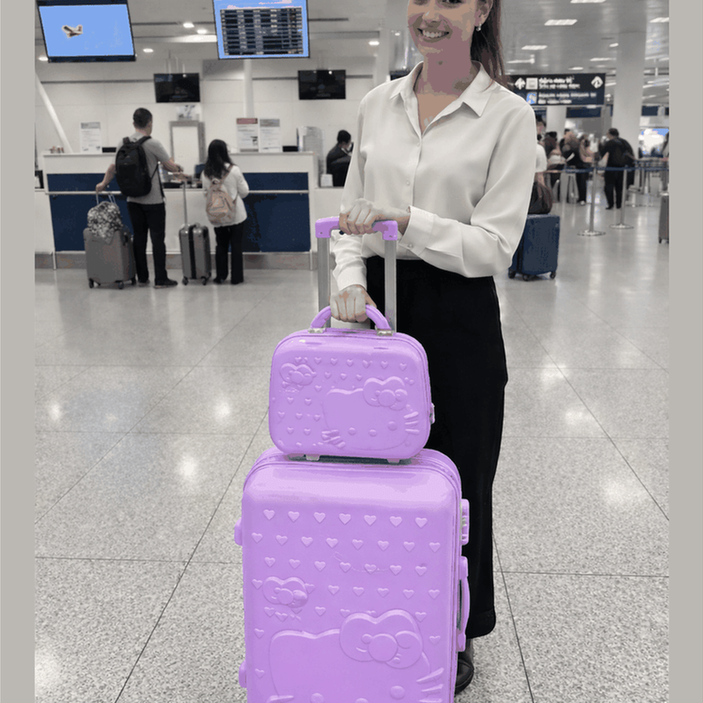 Close-up of Hello Kitty luggage set featuring colorful Hello Kitty character designs on hard shell carry-on