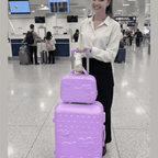 Close-up of Hello Kitty luggage set featuring colorful Hello Kitty character designs on hard shell carry-on