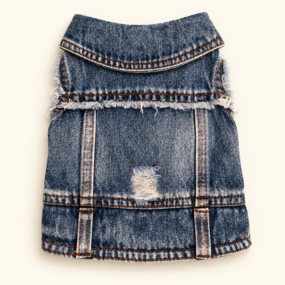 A blue denim vest for small pets, featuring a distressed ripped detail on the front and frayed edges, shown flat against a light cream background.