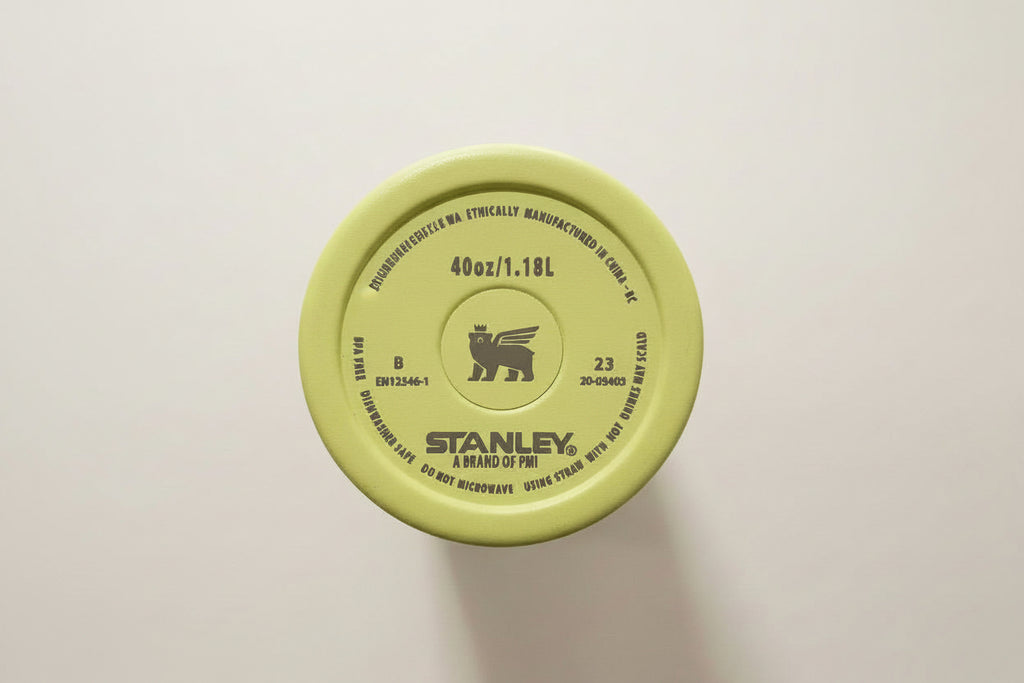 Stanley 40oz green insulated travel mug bottom with product details and logo