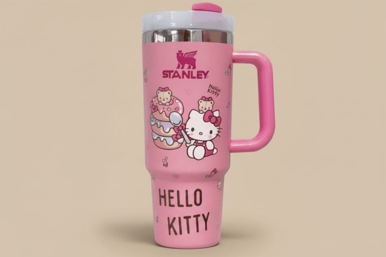 Pink Hello Kitty tumbler with insulated stainless steel travel cup and handle, featuring playful Hello Kitty and donut design, 40oz capacity.
