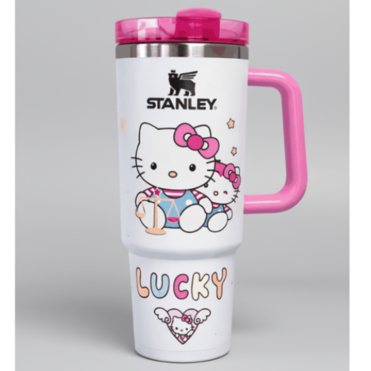 Stanley Hello Kitty pink and white travel mug with "Lucky" text and cartoon design
