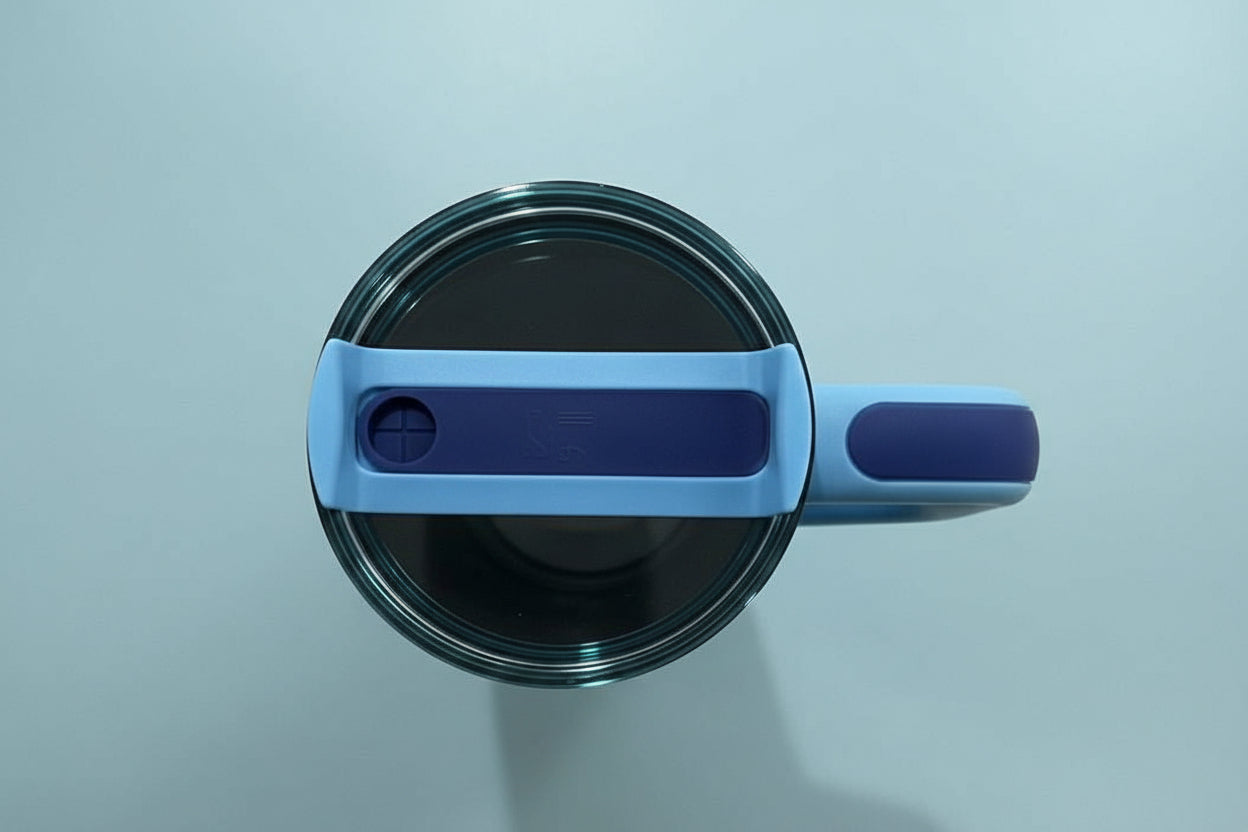 Blue mug with a matching lid on a beige background