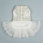 White Chanel-style tweed dog dress showing front view with pearl buttons and luxury pet fashion design