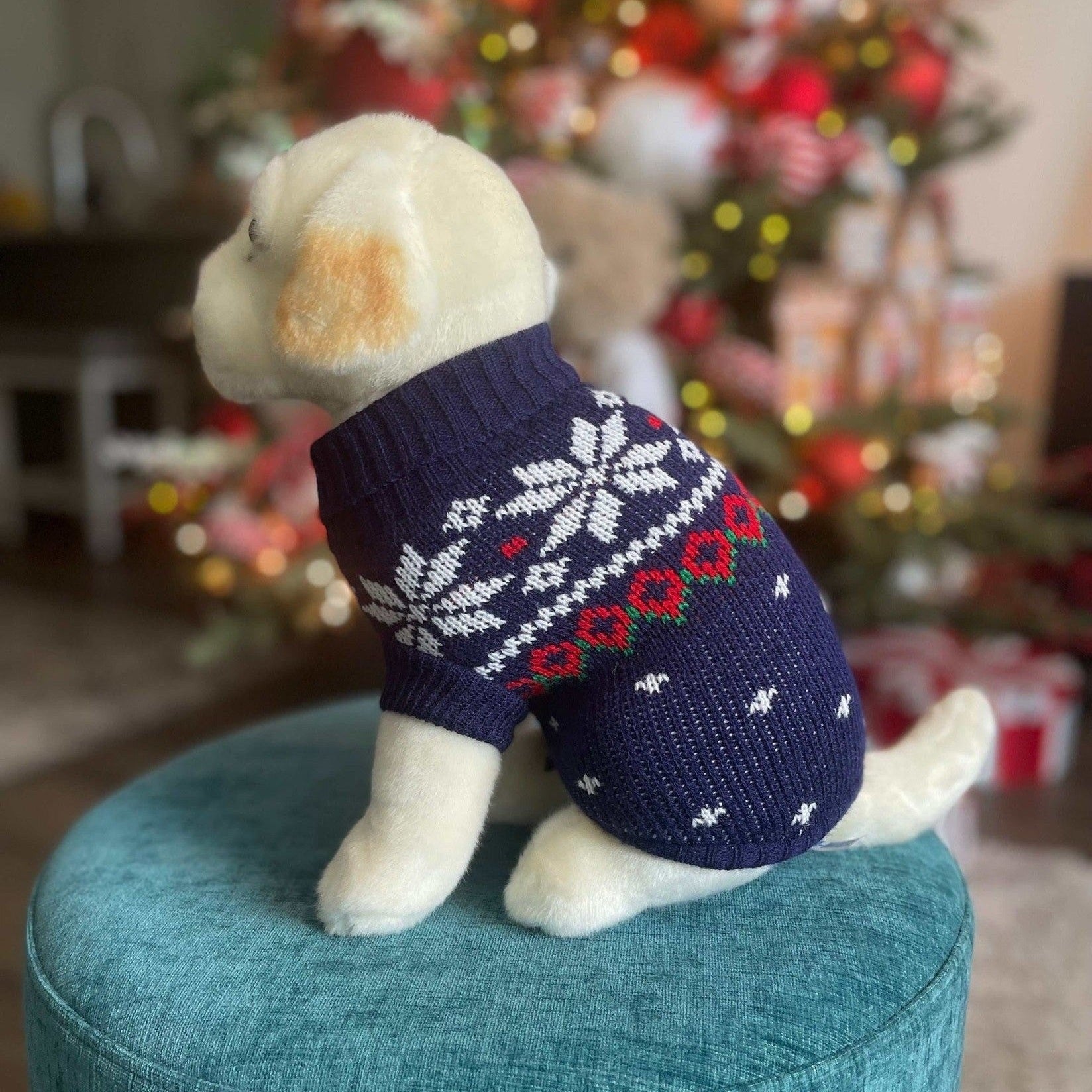 Navy blue snowflake dog sweater with red hearts and Nordic knit pattern on a dog mannequin.