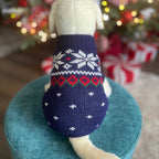 Close-up of navy blue snowflake dog sweater showing Fair Isle knit pattern with red hearts and snowflakes