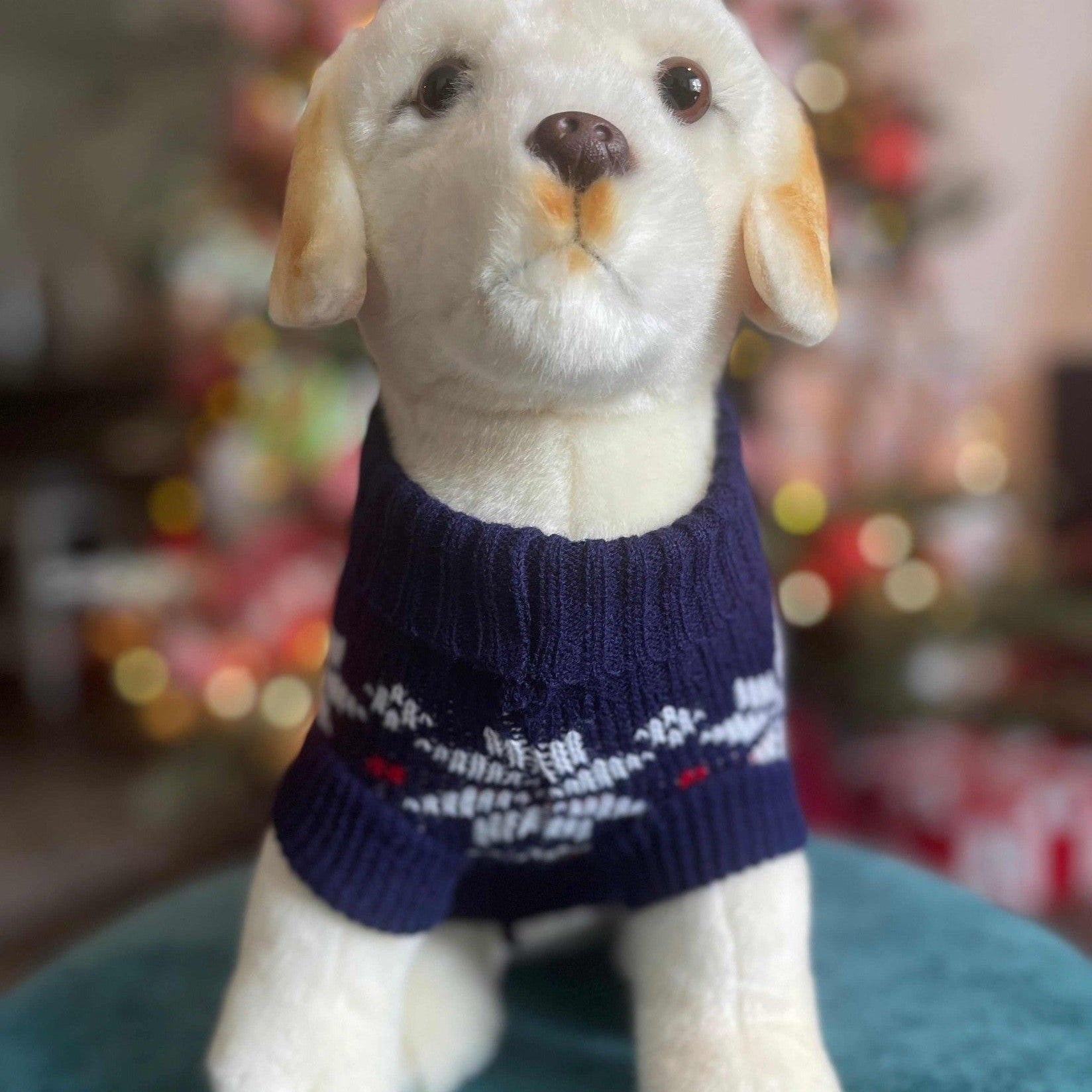 Detail of navy blue snowflake dog sweater displaying festive Nordic knit design and Christmas pattern