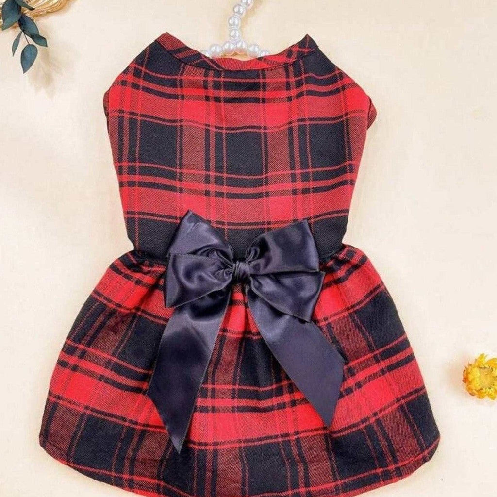 Red plaid dog dress flat lay showing tartan pattern with black satin bow and tulle layers
