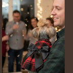 Back view of red plaid dog dress displaying holiday tartan pattern and dress construction