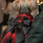 Red plaid dog dress detail showing black satin bow and festive Christmas party dress design