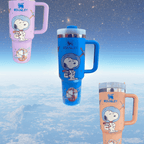 Snoopy Space 40 oz tumbler with engraved space-themed Snoopy, handle, and clear lid in blue, purple, and peach colors
