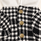 Close-up of three antique brass buttons and houndstooth tweed construction