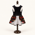 Front underside view of the Happy Halloween Bow dog dress on an espresso catalog stand