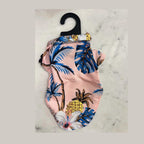 Flat lay of Hawaiian tropical style pet shirt showing full beach print design