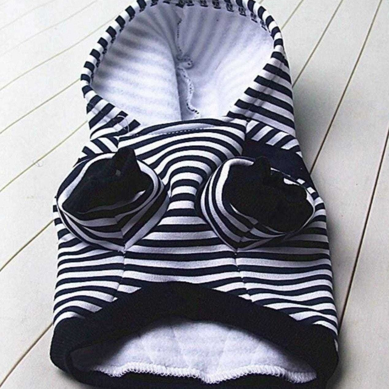 Front view of navy and white striped sailor dog hoodie showing leg openings and soft inner lining.