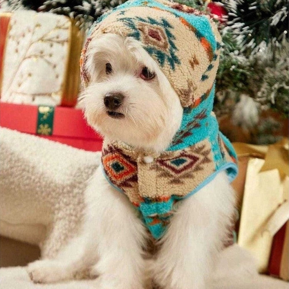 Small dog sitting indoors wearing Aztec Fleece Dog Hoodie with hood up.