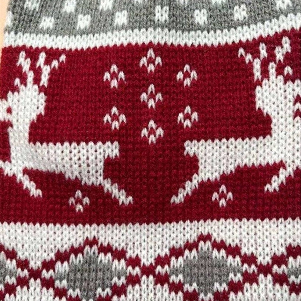Reindeer knit dog sweater showing side view of red and grey holiday pattern