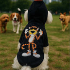Orange Pom Dog Hoodie black sweatshirt with orange pom and cartoon cheetah graphic on small dog in park