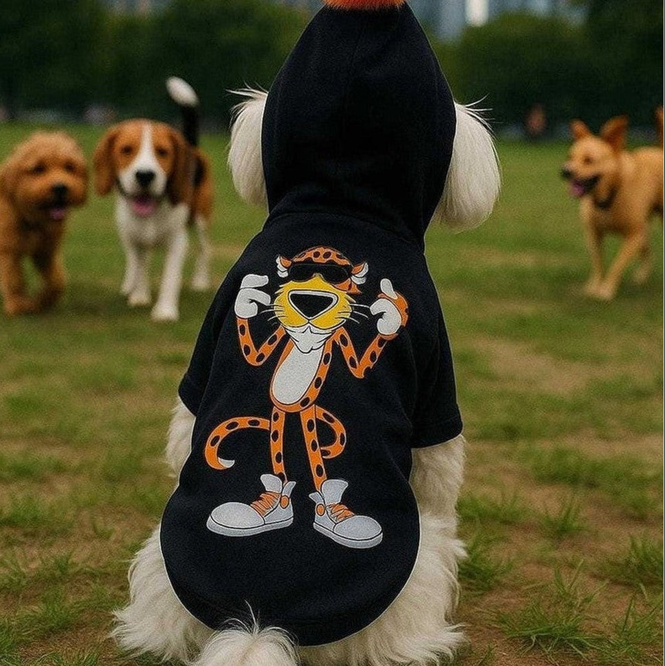 Orange Pom Dog Hoodie black sweatshirt with orange pom and cartoon cheetah graphic on small dog in park
