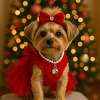 Small dog wearing festive red tulle pet dress with 3D rose bodice and satin bow in front of Christmas tree