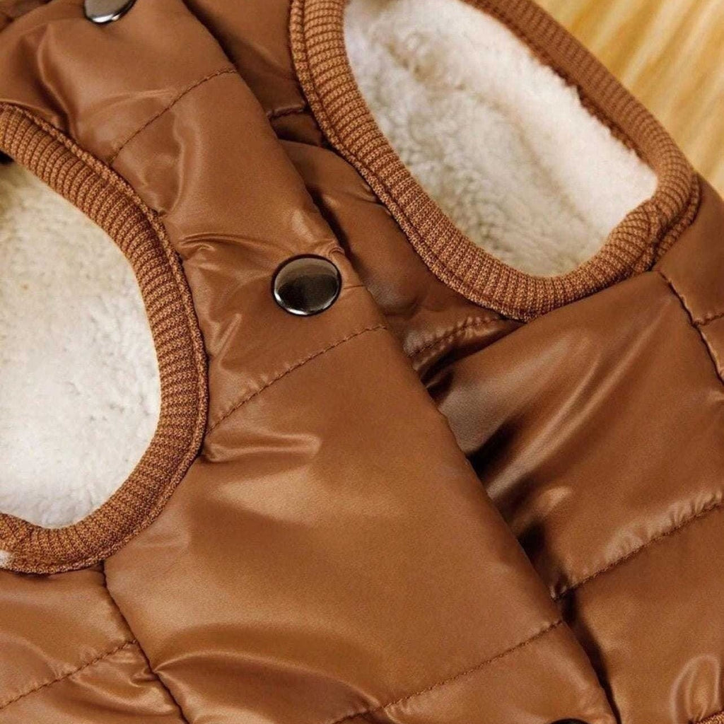 Close-up of a brown quilted jacket with fluffy lining on a beige background