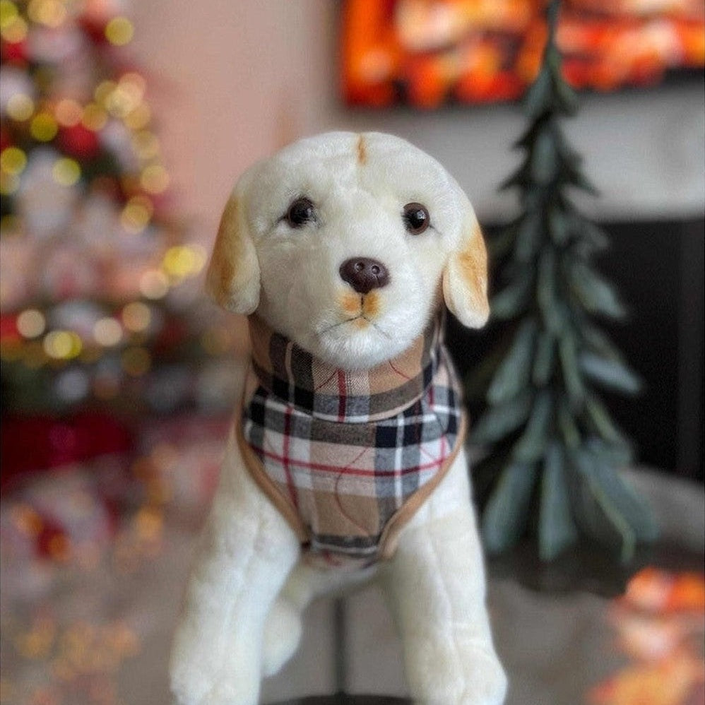 Stuffed dog toy with a plaid scarf in a festive room with Christmas decorations.
