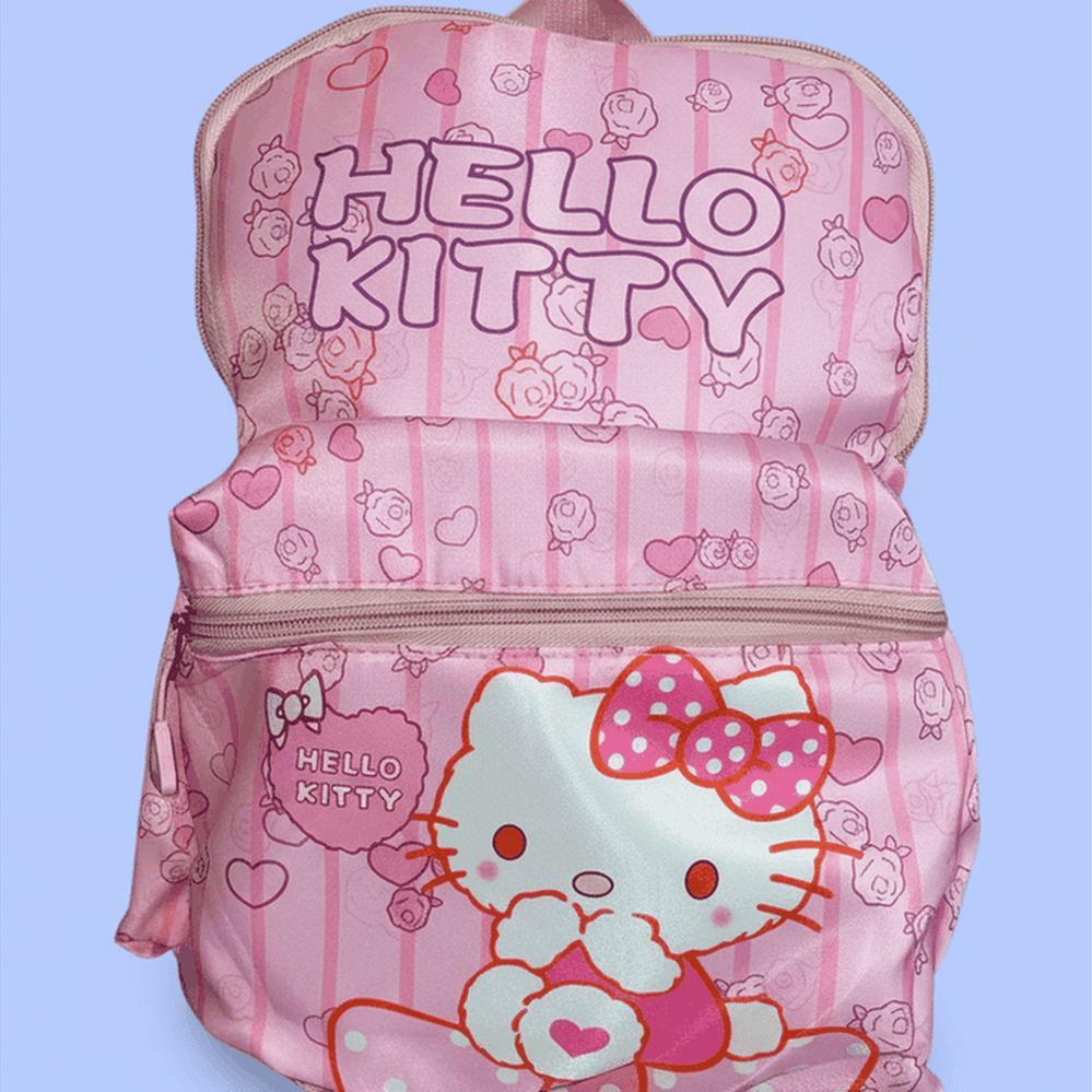 Hello Kitty pink backpack front view with HELLO KITTY text, large Hello Kitty face and bow pattern on periwinkle blue background