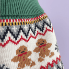Close-up detail of gingerbread dog sweater showing Fair Isle knit pattern with gingerbread men, snowflakes and zigzag design on lavender background