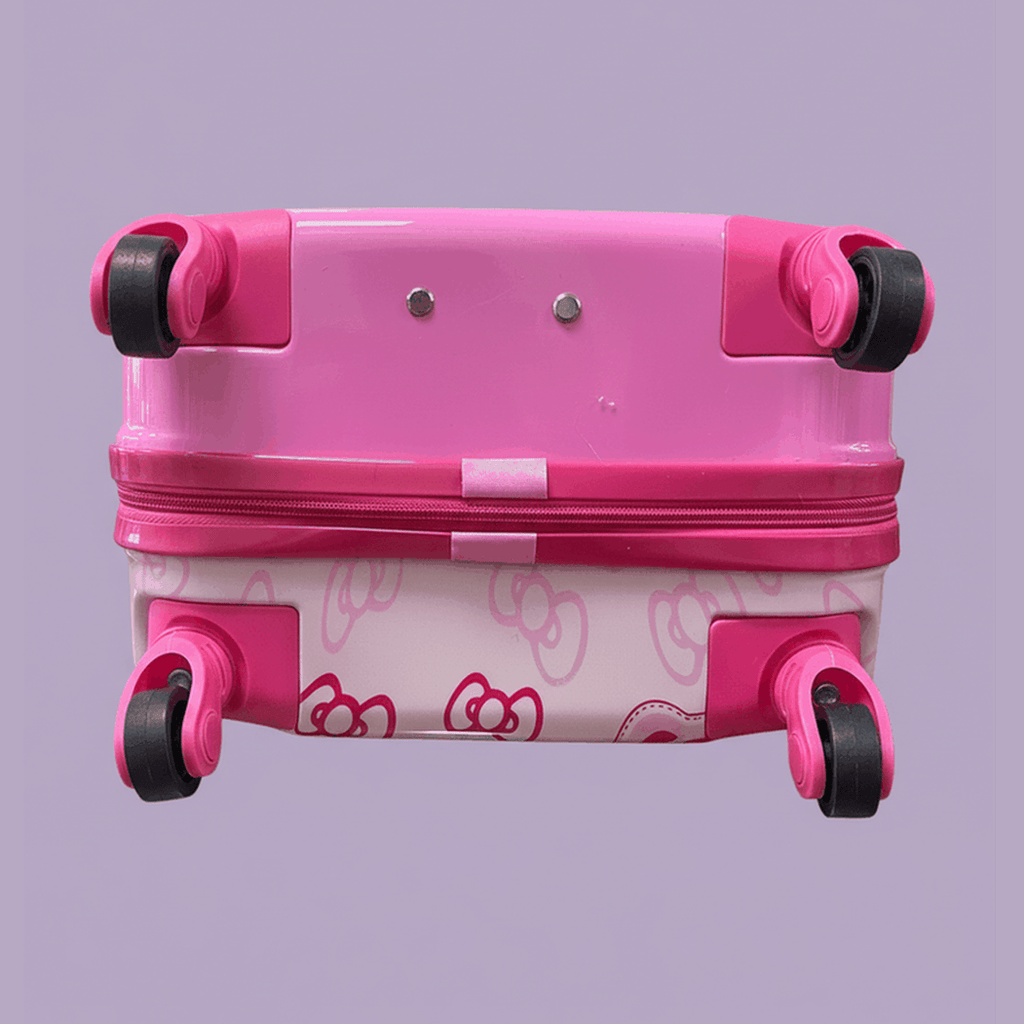 Bottom view of Hello Kitty pink suitcase showing four spinner wheels and bow pattern on lavender background