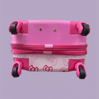 Bottom view of Hello Kitty pink suitcase showing four spinner wheels and bow pattern on lavender background