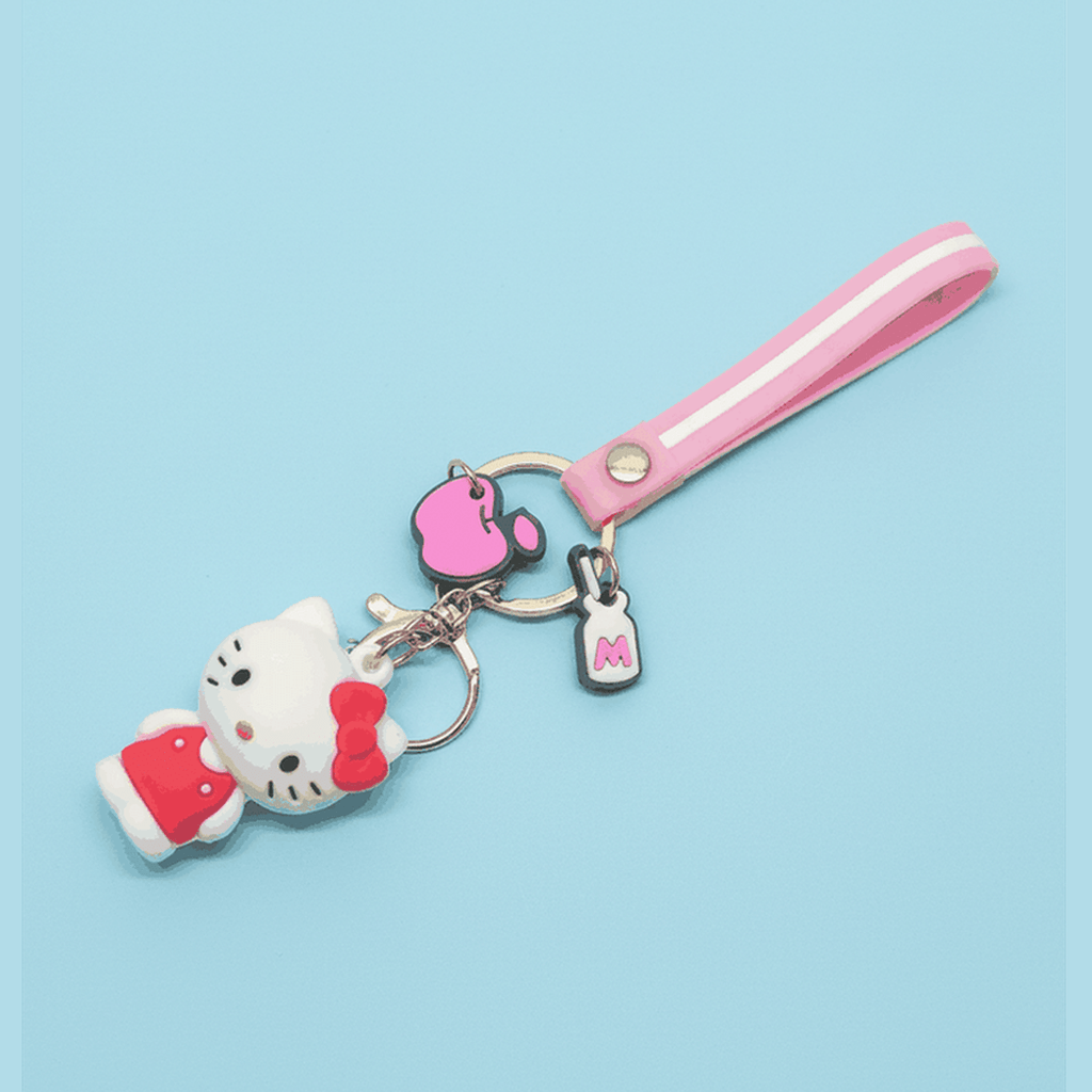 Adorable Hello Kitty pink charm keychain with bow detail included with Sanrio backpack set on blue background
