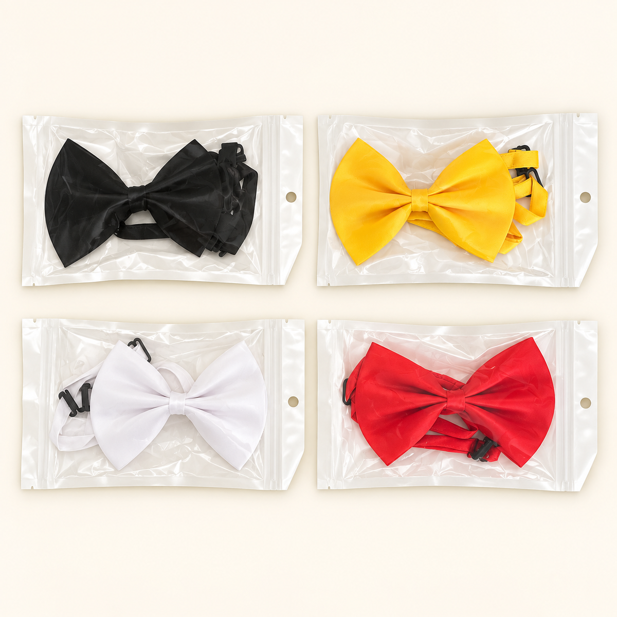 Set of four packaged dog bow ties in black, yellow, white and red