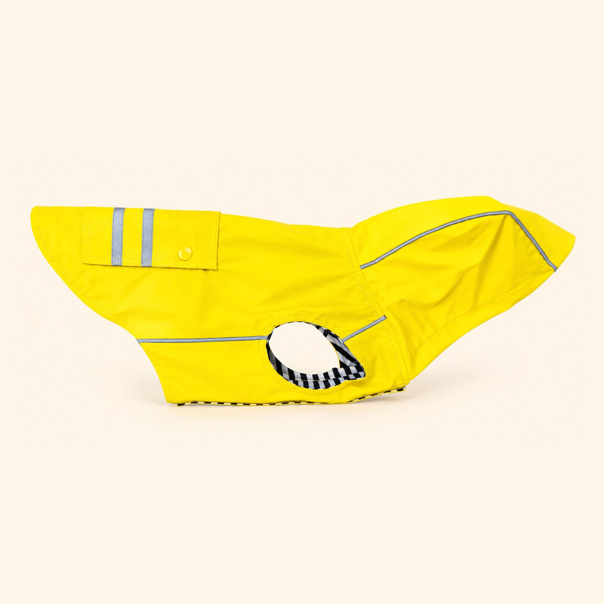 Yellow Slicker dog raincoat seen from the side, showing the extra-wide belly closure and the striped trim around the leg opening