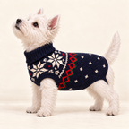 White Westie wearing the Navy Snowflake Dog Sweater on a cream studio background