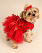 Keka wearing red tulle dress, elevated three-quarter view showing bow and layered skirt